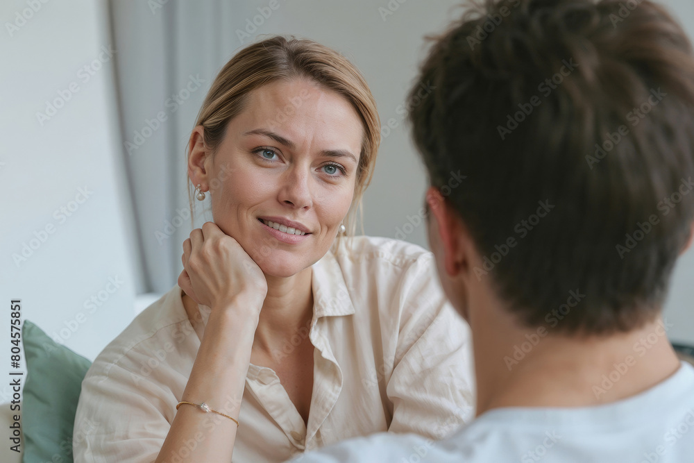 Family psychologist European woman talking to a client in private clinic. European couple at home sitting in sofa and having a talk Family psychologist European woman talking to a client in private clinic. European couple at home sitting in sofa and having a talk