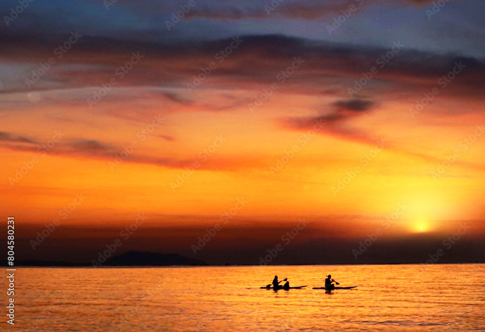 Silhouette of two people kayaking on the sea at sunset, young couple on a kayak on the sea at dusk under the light of the big moon Actively rest Swim away from problems privacy concept. - image