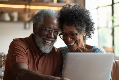 Radiating happiness, a mature couple shares a moment of love and connection as they engage in an online video call together on their laptop, exemplifying active communication and affection in their