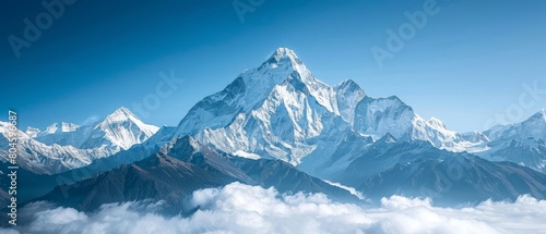 A single mountain peak against a clear blue sky photo