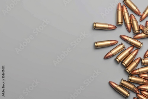 A pile of bullet casings on a gray surface. Suitable for military and crime-related themes