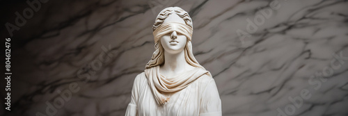 blindfolded Lady Justice. Close up visage of a sculpture of Themis, blindfold impartiality. Grey marble background. Space for text, light theme background, isolated.
