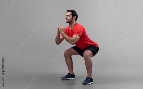 Full body length gaiety shot athletic and sporty young man with fitness in squat exercise posture on isolated background. Healthy active and body care lifestyle.