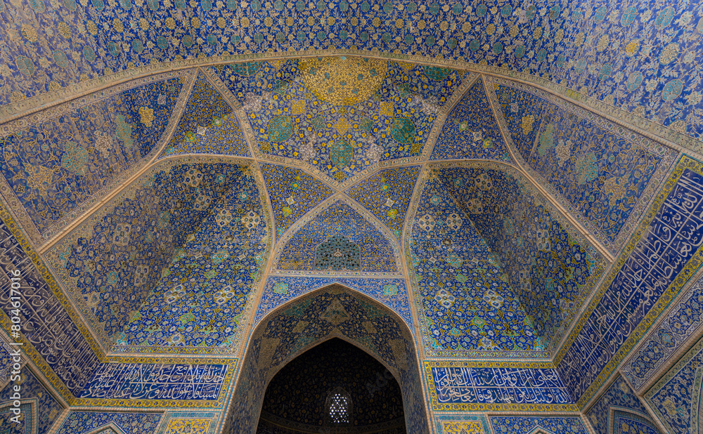 Stunning Persian-Islamic architecture with minarets and intricate tiles in vibrant blue tones. Imam Mosque, Naqsh-e Jahan Square, Isfahan, Iran.