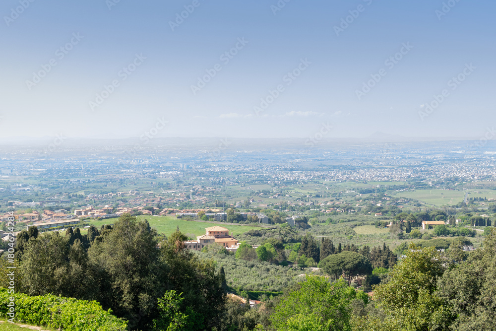 Stunning view from the valley's overlook, revealing the outskirts of Rome on a sunny day against the backdrop of the distant horizon