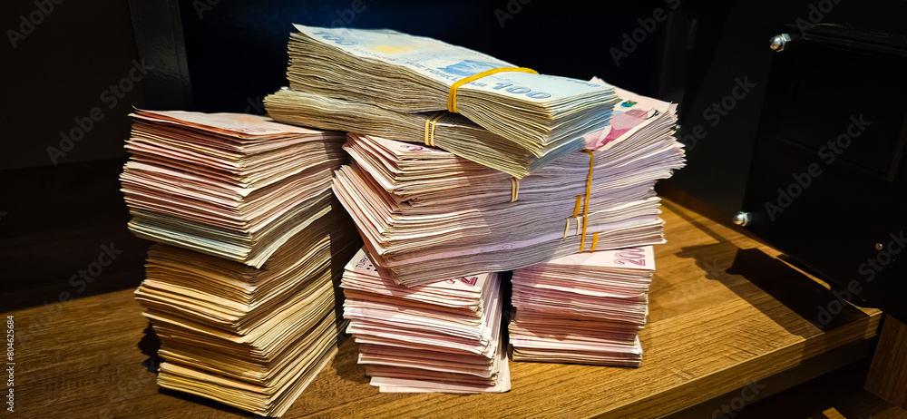Fototapeta premium Bales of Turkish Lira banknotes in the bank in front of the cash register