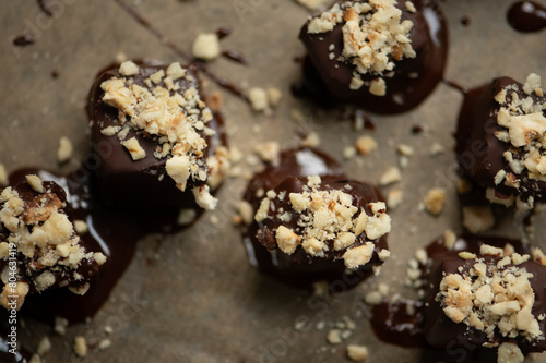 Hazelnut-date confectionery, vegan, very creamy, covered with dark chocolate with coconut blossom sugar and chopped hazelnuts