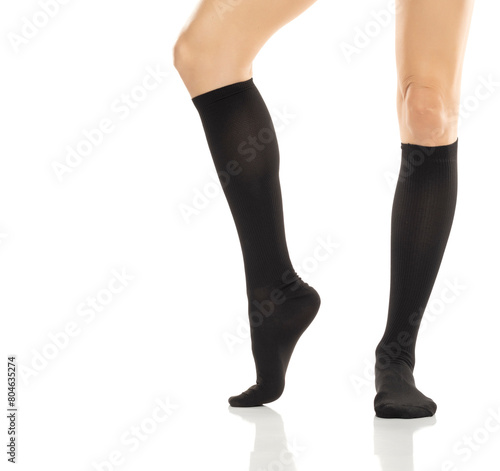 Female legs in compression Hosiery. Medical stockings, tights, socks, calves and sleeves for varicose veins and venouse therapy. Clinical knits. Sock for sports isolated on white background