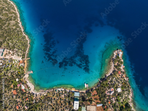 Fototapeta Naklejka Na Ścianę i Meble -  An aerial view of Limanagzi Beach in Kas, Antalya, Turkey, showcasing the turquoise sea, coastline, and surrounding nature from above.