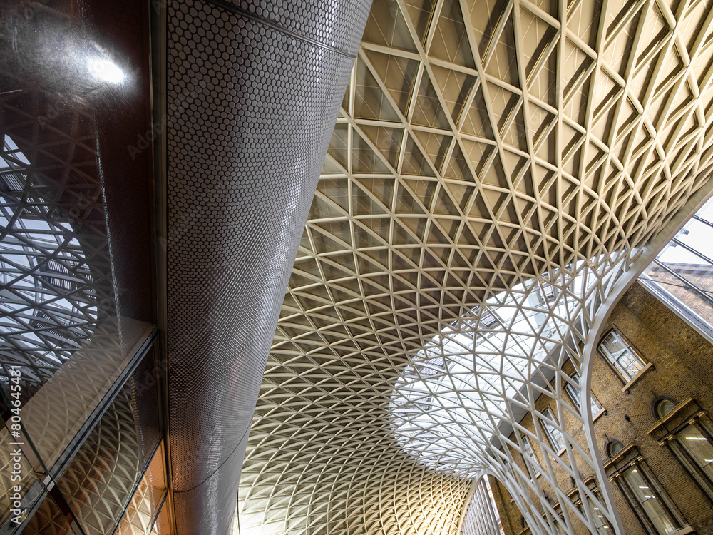 Fototapeta premium London, United Kingdom - February 26, 2024: Kings Cross railway station in London. The modern metal structure merges with the old architecture