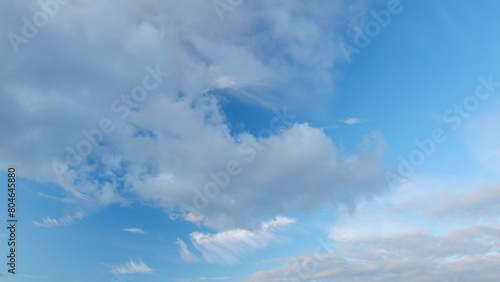 Cloud nature background. Blue sky with cirrus clouds and sun. Nature background of airy cloudscape. Timelapse.