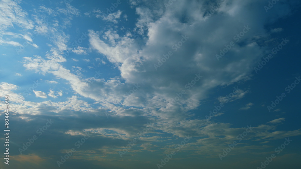Sun rays and clouds in blue sky. atural sky backdrop weather conditions. Beautiful blue sky with sunbeams and clouds. Timelapse.