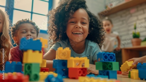 Joyful child playing with colorful blocks photo
