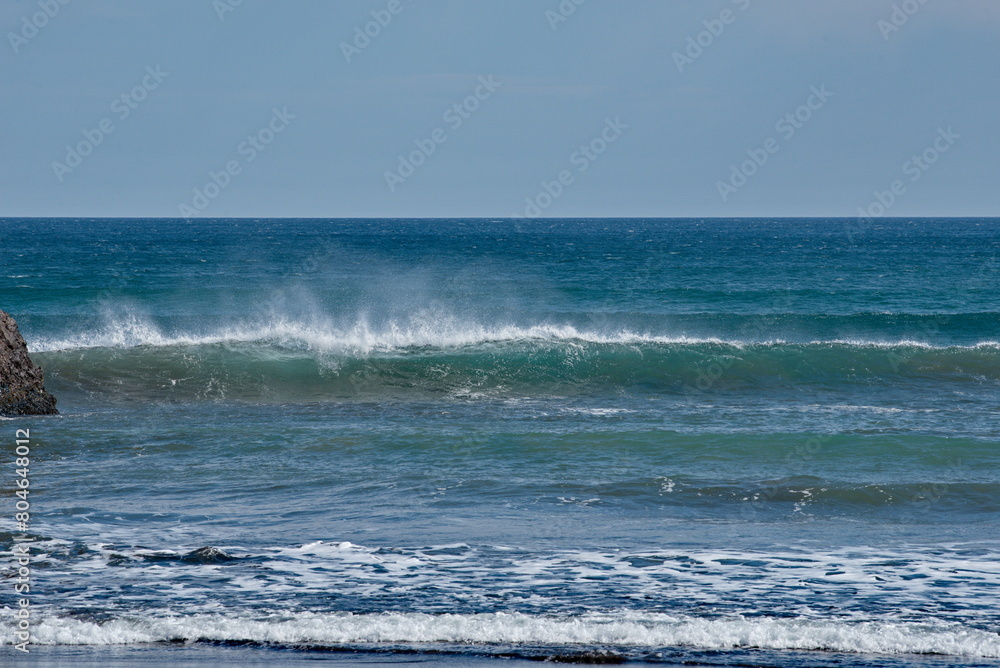 Russia. The Far East. The Kuril Islands. Storm waves coming towards the gusty wind from the shore of Iturup Island in the Sea of Okhotsk. Russia. The Far East. The Kuril Islands. Storm waves coming towards the gusty wind from the shore of Iturup Island in the Sea of Okhotsk.