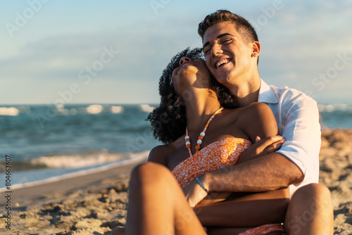 Interracial Couple Embracing on Beach - Summer Romance © Lomb