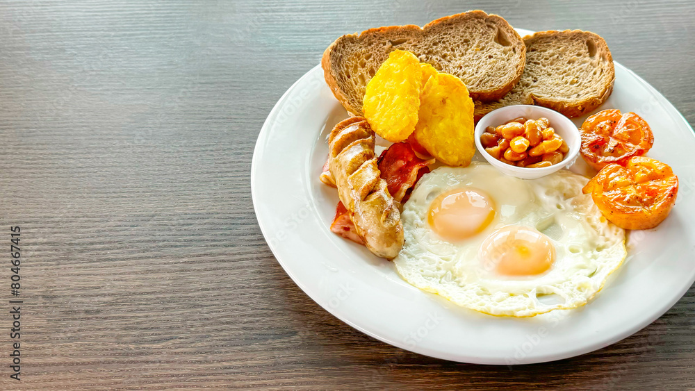 Hearty traditional breakfast plate with eggs, bacon, tomatoes, and bread caters to a trend towards wholesome meals, emphasizing a balanced, nourishing start to the day. Comfort food. Copy space Hearty traditional breakfast plate with eggs, bacon, tomatoes, and bread caters to a trend towards wholesome meals, emphasizing a balanced, nourishing start to the day. Comfort food. Copy space