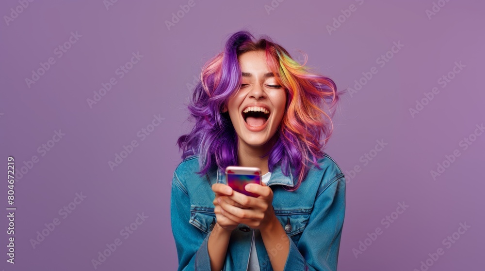 Naklejka premium Happy young woman with colored hair holding a smartphone, screaming laughing