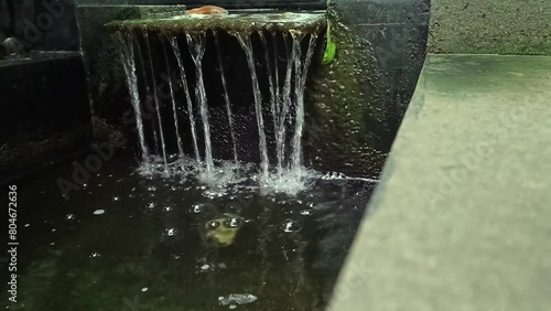 The artificial fountain in the fish pond