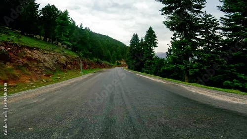 First-person footage of driving, serpentine mountain road. Video shows driving, serpentine path through scenic area. Captures experience of driving, serpentine route in mountains photo