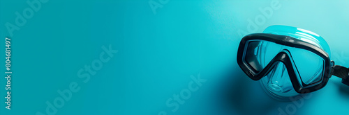 Snorkel mask web banner. Snorkel mask isolated on turquoise background with copy space. photo