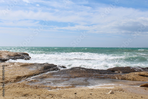 natural background of sky  sea and rocks  Mediterranean coast in Spain  waves on the beach