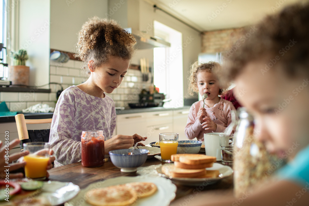 Happy single father having breakfast together with children at home Happy single father having breakfast together with children at home