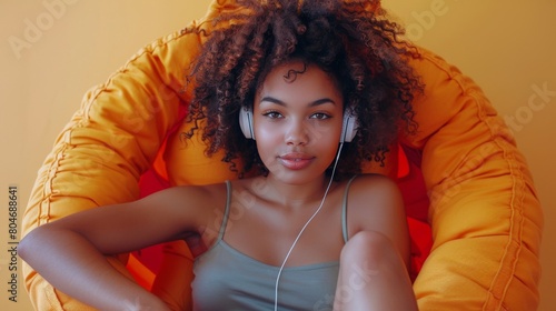 Woman Sitting in Chair With Headphones On