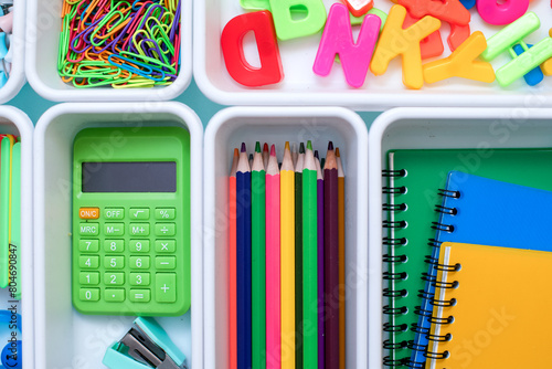 School supplies.Concept back to school. colored stationery is arranged in white organizers. Creative Drawer Organizing. Storage office supplies.