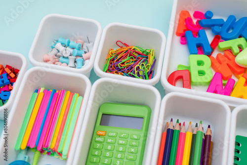 School supplies.Concept back to school. colored stationery is arranged in white organizers. Creative Drawer Organizing. Storage office supplies.