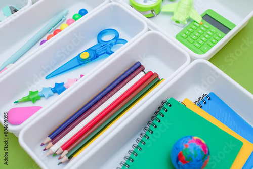School supplies.Concept back to school. colored stationery is arranged in white organizers. Creative Drawer Organizing. Storage office supplies.