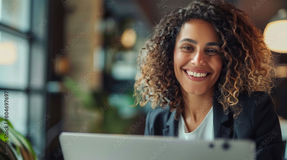 Portrait of a young woman sitting with a laptop in a modern office. Smiling woman working with a laptop computer. Freelancing concept. Lifestyle. Portrait of a young woman sitting with a laptop in a modern office. Smiling woman working with a laptop computer. Freelancing concept. Lifestyle.