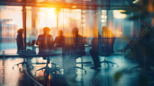 Wallpaper Mural Silhouetted business people in a modern office with glass walls during sunset, creating a warm, dynamic atmosphere. Torontodigital.ca