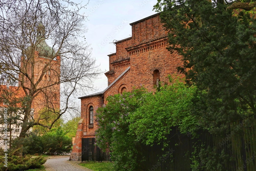 An alley in the park among the monuments on Tumskie Hill in Plock, Poland