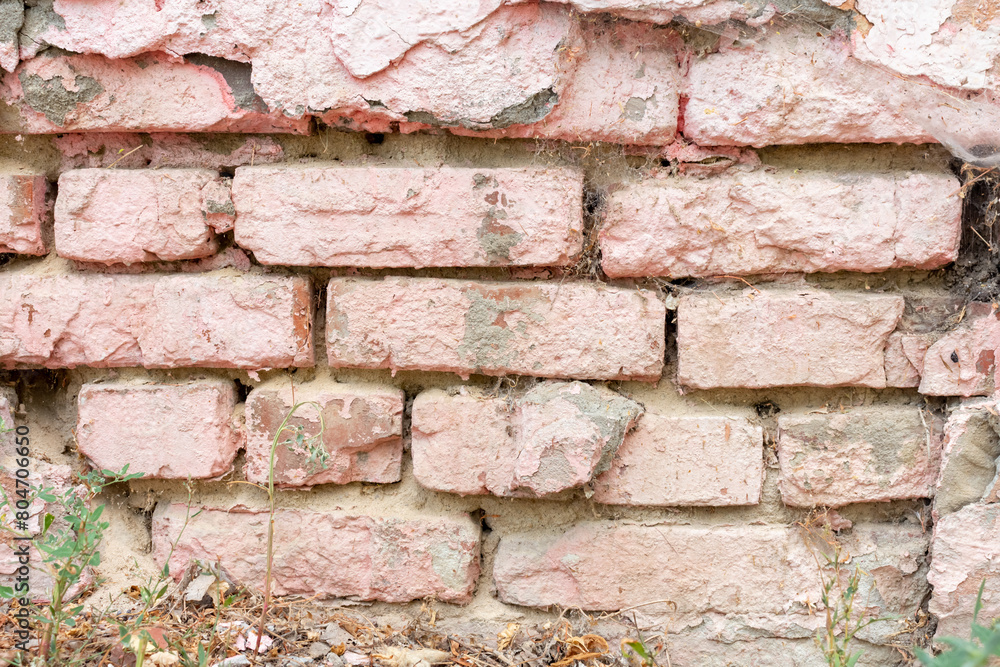Pink brick wall background. Close-up view of weathered painted pink brick wall surface covered with spots and streaks. Copy space for your text and decorations. Abstract backdrop theme. Pink brick wall background. Close-up view of weathered painted pink brick wall surface covered with spots and streaks. Copy space for your text and decorations. Abstract backdrop theme.