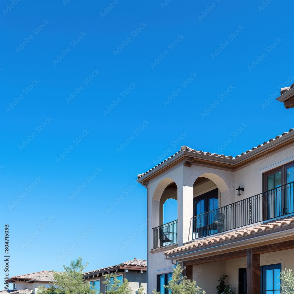 Elegant Tuscan style villa with arched balconies and terracotta roofs under a blue sky Elegant Tuscan style villa with arched balconies and terracotta roofs under a blue sky