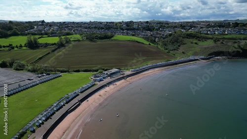Broadsands, Torbay, South Devon, England: DRONE VIEWS: The drone spirals downwards over Broadsands beach as a lone windsurfer cuts across the bay. Broadsands is a popular English holiday resort. photo