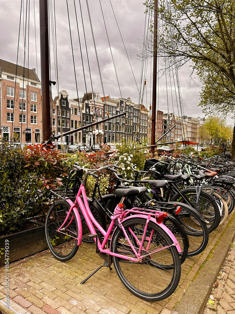 Row Of Bicycles Standing In Front Of Beautiful Amsterdam Cityscape, Netherlands