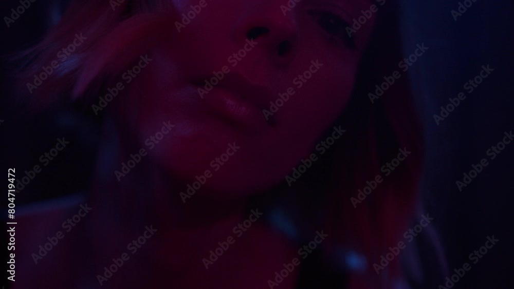A young woman appears from behind the blinking curtain A young woman appears from behind the blinking curtain
