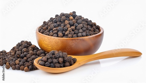 close up black pepper seeds or peppercorns dried seeds of piper nigrum in wooden bowl and spoon isolated on white background photo