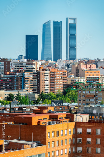 Skyscrapers of Madrid's financial district emerge among the buildings of the city, Spain. photo