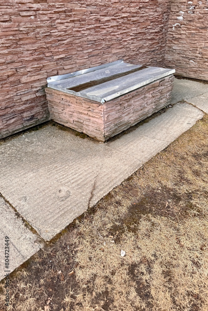 Basement opens in the building of house has window is located below ground level around facing brick. Window is covered with galvanized steel sheet to protect basement from precipitation during rain Basement opens in the building of house has window is located below ground level around facing brick. Window is covered with galvanized steel sheet to protect basement from precipitation during rain