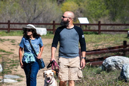 A family of a Mother and Son Hiking a Trail Together with their Dog.