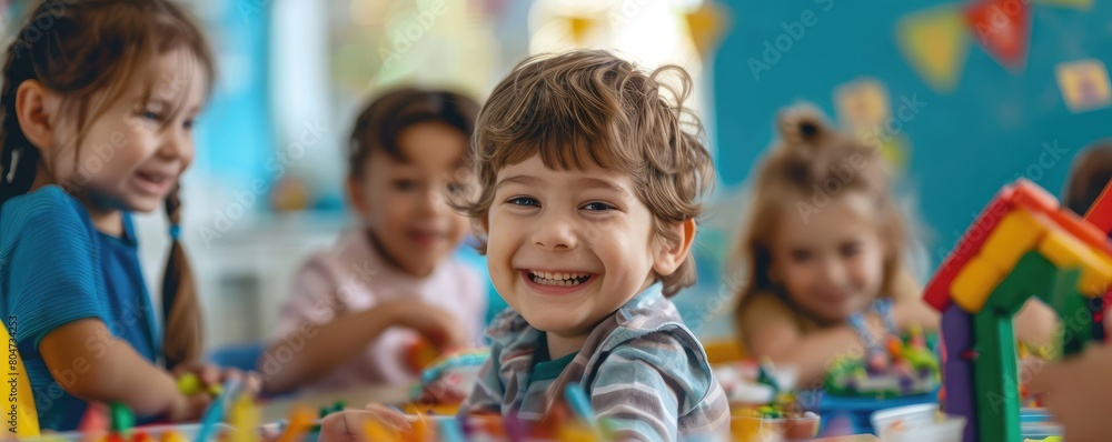 Happy child playing with colorful toy blocks among friends in a vibrant classroom.