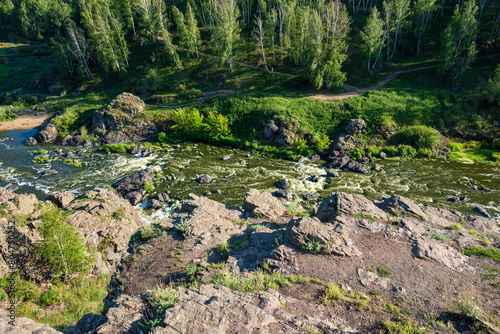 A river meandering through dense green plant communities in a natural landscape photo