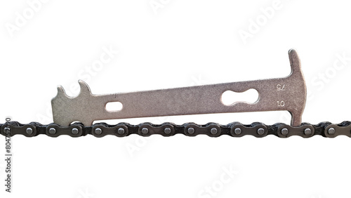 Isolated photo of chain checker tool for worn bicycle chain