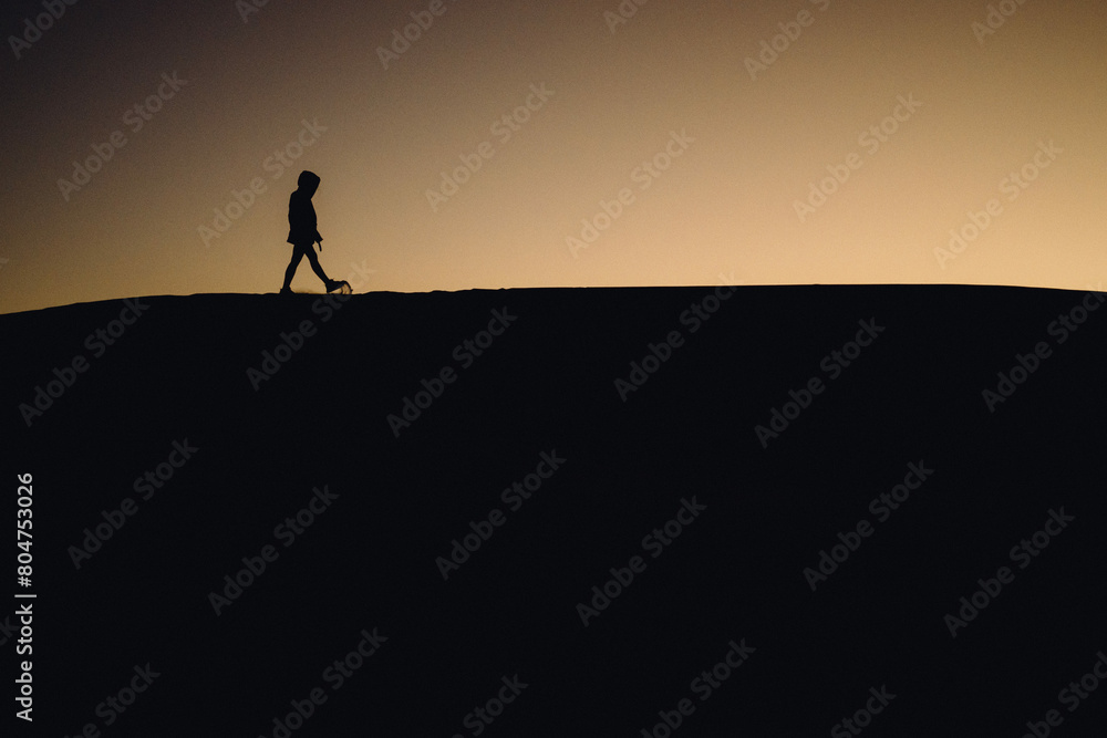 silhouette of a person in the mountains