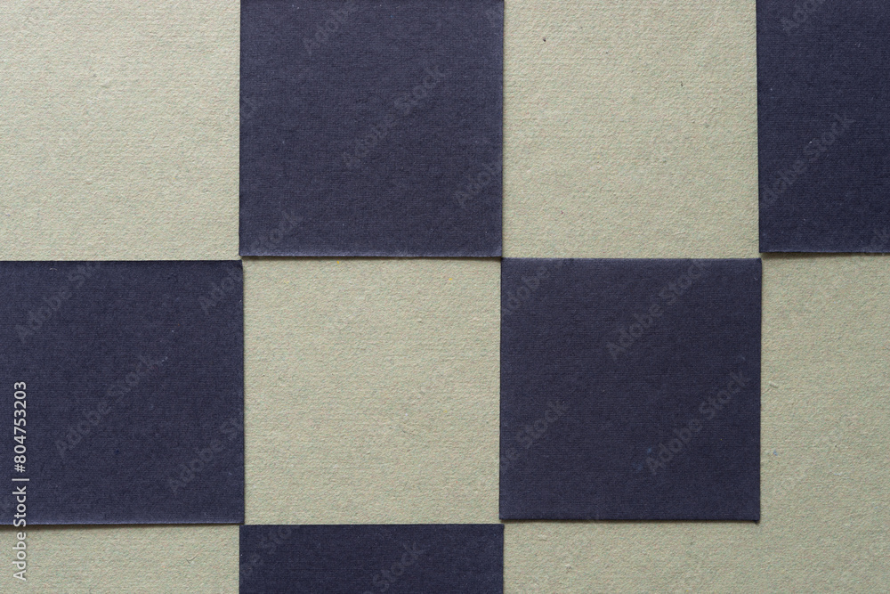 checkered background with black paper tiles on green checkered background with black paper tiles on green