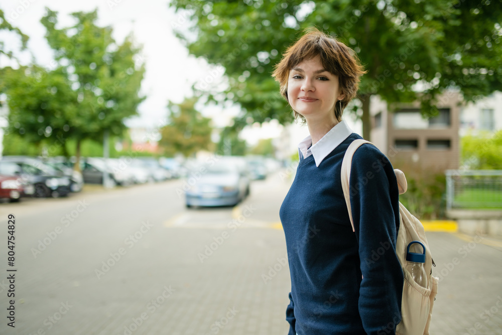 Cute young girl with a backpack heading to school on warm autumn morning. Child going back to school. Cute young girl with a backpack heading to school on warm autumn morning. Child going back to school.