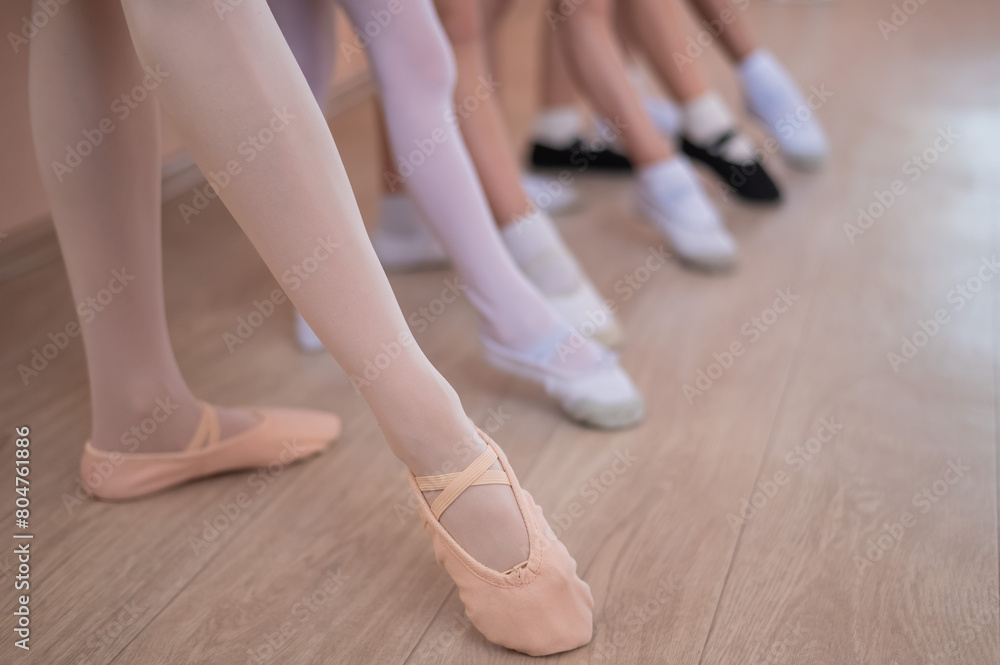 Close-up of feet of 5 little girls and teacher at ballet class. Close-up of feet of 5 little girls and teacher at ballet class.