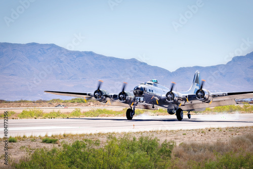 A four engine World War Two era heavy bomber lands at a New Mexico airport.